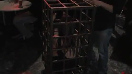 Public party plays with caged slave